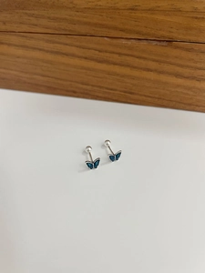 Macro detail of blue enamel butterfly stud earring with secure silver screw back closure