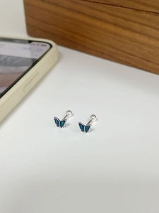 Detail of blue enamel butterfly stud earrings with secure screw-on ball backings