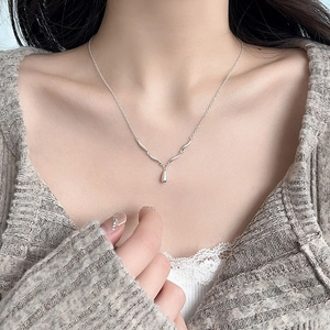 Elegant S925 sterling silver water drop wave pendant necklace shown on a female model