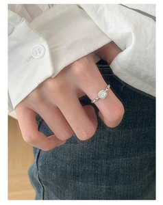 Detail of silver chain ring with square halo crystal on woman finger in daily wear