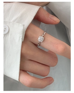 Detailed view of silver ring with square crystal cluster and hollow chain link band