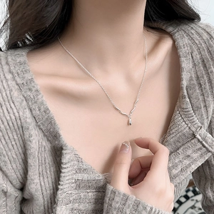 Minimalist S925 sterling silver water drop wave necklace worn by model on collarbone