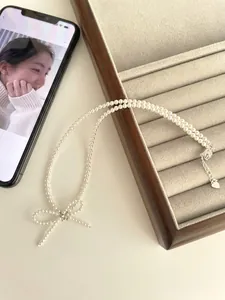 Close-up of double-layer S925 silver pearl necklace with a sparkling cubic zirconia bow