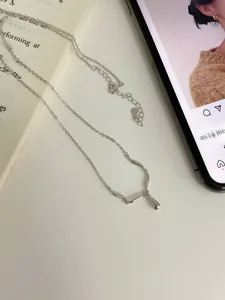 Detailed macro view of S925 sterling silver water drop pendant on a minimalist chain