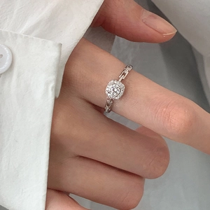 Elegant silver square cluster ring with chain design band worn on a model finger