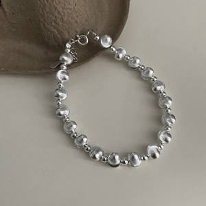 Detailed view of S925 sterling silver beaded bracelet with textured and polished beads
