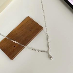 Minimalist S925 sterling silver water drop wave necklace for women on wood block