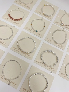Macro detail of S925 sterling silver bracelets with pearls, crystals and lobster clasp