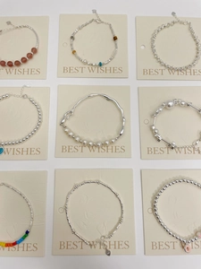 Detailed view of S925 silver beaded bracelets with freshwater pearls and heart pendants