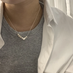 Minimalist S925 silver heart necklace with freshwater pearls shown on a female model