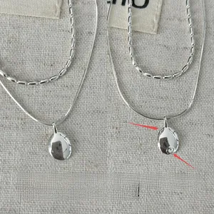 Detail view showing front and back of the double-layer silver olive bead necklace