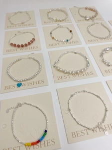 Detailed macro view of S925 silver pearl bracelets with colorful beaded heart pendants