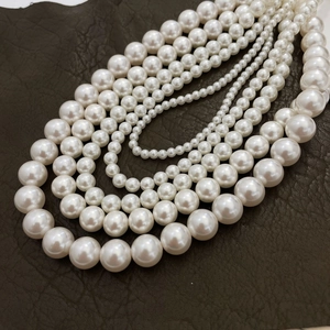 Lustrous white 925 sterling silver pearl necklace layered on textured leather background