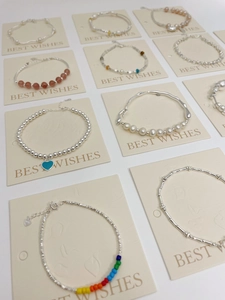 Collection of S925 silver pearl bracelets with textured designs and colorful beads