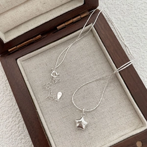 Close-up of S925 silver star pendant with smiley face and hallmarked lobster clasp