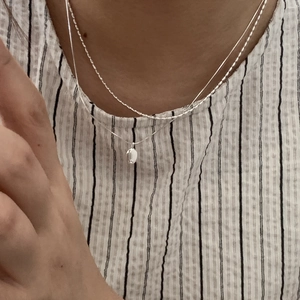 Minimalist S925 sterling silver layered necklace with oval pendant on a female model