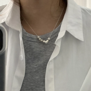 Close-up of S925 silver heart necklace with fresh water pearls worn on neck