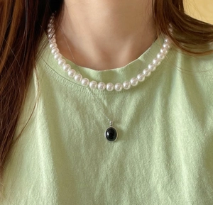 Layered 925 sterling silver chain with a black oval pendant and round pearl necklace