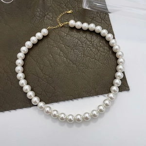 Detailed view of 925 sterling silver pearl necklace with gold lobster clasp and extension chain