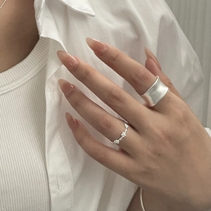 Minimalist matte silver ring set with wide textured band and delicate floral pattern