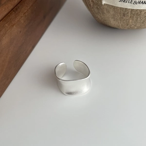 Detail of matte S925 sterling silver wide open ring with brushed metal texture finish