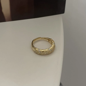 Close-up of vintage gold S925 sterling silver wheat ring with cubic zirconia stones