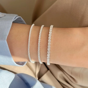 Three S925 sterling silver tennis bracelets with white cubic zirconia worn on wrist