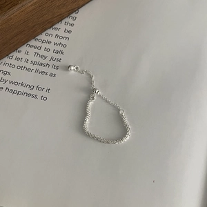 Detail of S925 sterling silver adjustable tassel ring with shimmering popcorn chain texture