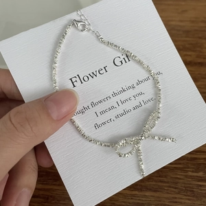 S925 sterling silver bow necklace featuring irregular crushed silver texture and chain