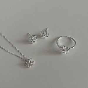 Gros plan sur l'ensemble de bijoux en argent S925 avec collier et boucles fleurs évidées