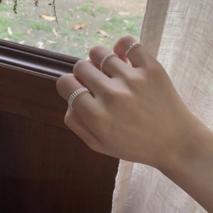 Detailed close-up of a three-piece S925 sterling silver stacking ring set on hand