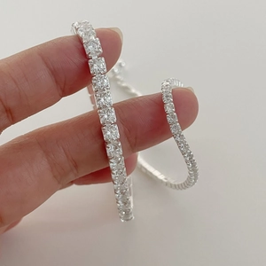Macro detail of S925 sterling silver tennis bracelet with princess cut cubic zirconia stones