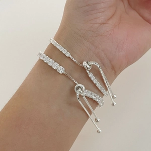 Macro shot of silver tennis bracelet featuring sparkling square zirconias on wrist