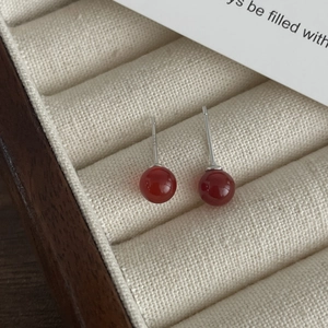Macro shot of red agate stud earrings with S925 sterling silver hallmarked needles