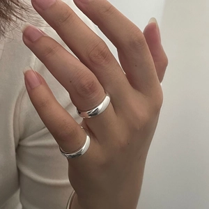 Close-up of polished S925 sterling silver dome rings worn on model fingers