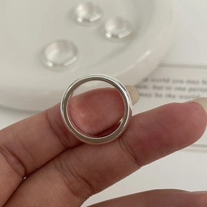 Polished S925 silver minimalist dome ring shown on a finger with a warm aesthetic