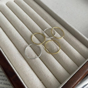 Close-up of minimalist gold and silver 925 sterling silver thin stackable rings set
