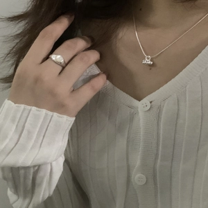 Detail of S925 silver beaded cluster necklace and white pearl ring on model