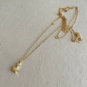 Macro detail of S925 silver star necklace showing matte texture and zircon inlay