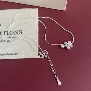 Detail of S925 sterling silver grape cluster pendant on elegant snake chain