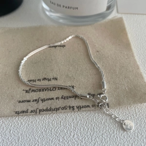 Macro shot of S925 sterling silver bracelet detail with hallmark engraving on fabric