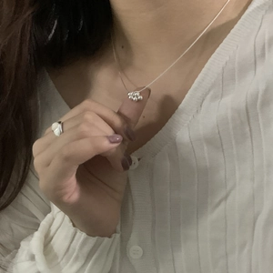 Detail shot of a silver S925 necklace with a grape cluster pendant and matching ring
