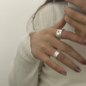 Minimalist S925 sterling silver wide rings with hand-hammered texture on model finger