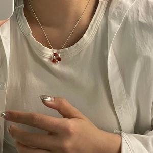 Close-up of S925 silver beaded necklace featuring red agate and silver ball pendant