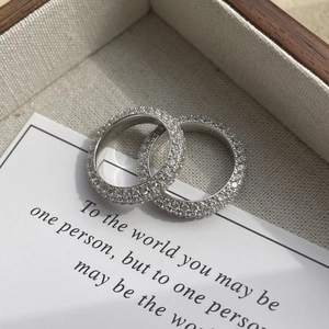 Macro shot of 925 sterling silver full eternity rings with S925 hallmark and pave set diamonds