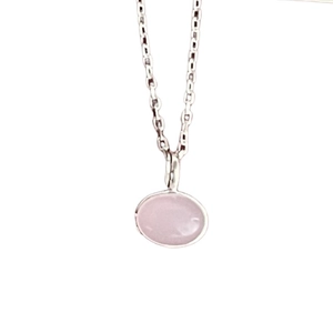Minimalist 925 sterling silver necklace featuring an oval pink crystal pendant in white background