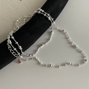Close-up of S925 sterling silver beaded chain with water drop pendant and extension link