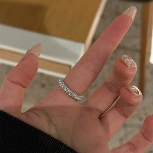 Detail view of 925 silver eternity ring with sparkling stones on model's hand