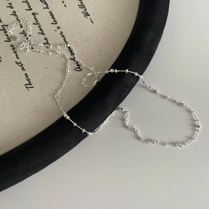 Macro shot of S925 sterling silver beaded chain with elegant texture and extender