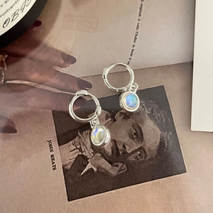 Minimalist S925 silver drop earrings with iridescent moonstone on artistic book